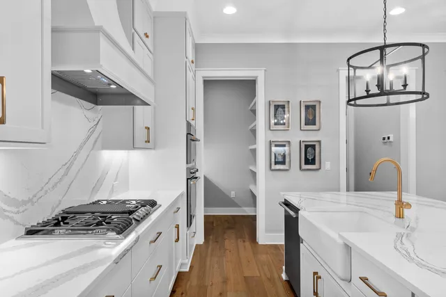 a kitchen with stainless steel appliances granite countertop a stove and a sink