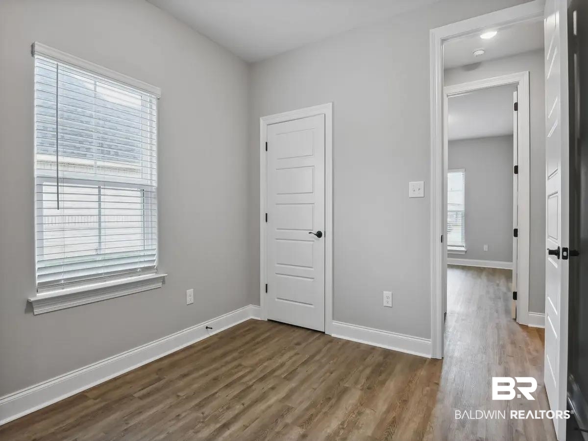 10174 Grady Lane Mobile, AL 36695 - Photo 12 of 14 Unfurnished bedroom featuring dark wood-style floors and a closet
