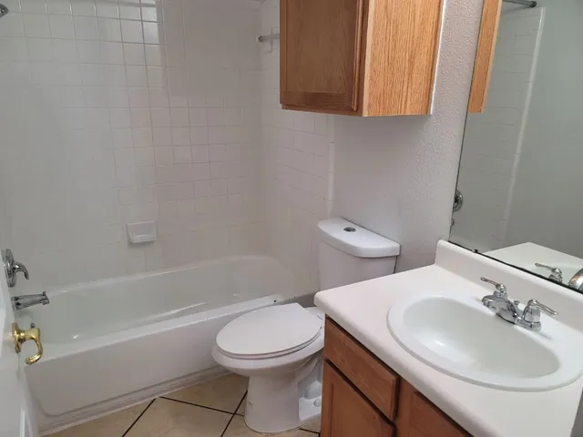 a bathroom with a toilet a sink and bathtub