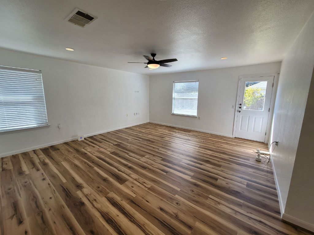 707 Windledge Drive Austin, TX 78745 - Photo 4 of 25 wooden floor in an empty room with a window