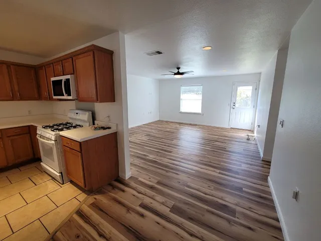 a kitchen with stainless steel appliances granite countertop a stove and a wooden cabinets