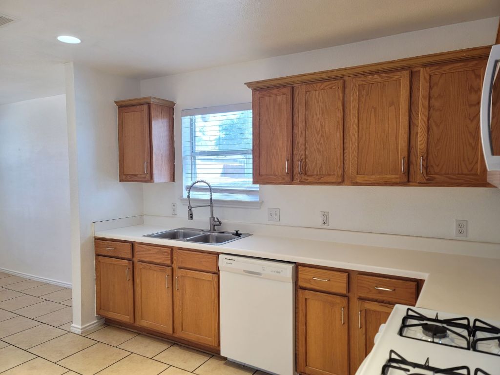 707 Windledge Drive Austin, TX 78745 - Photo 8 of 25 a kitchen with a sink and cabinets