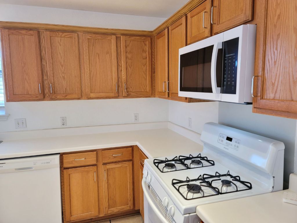 707 Windledge Drive Austin, TX 78745 - Photo 9 of 25 a kitchen with a stove and a microwave