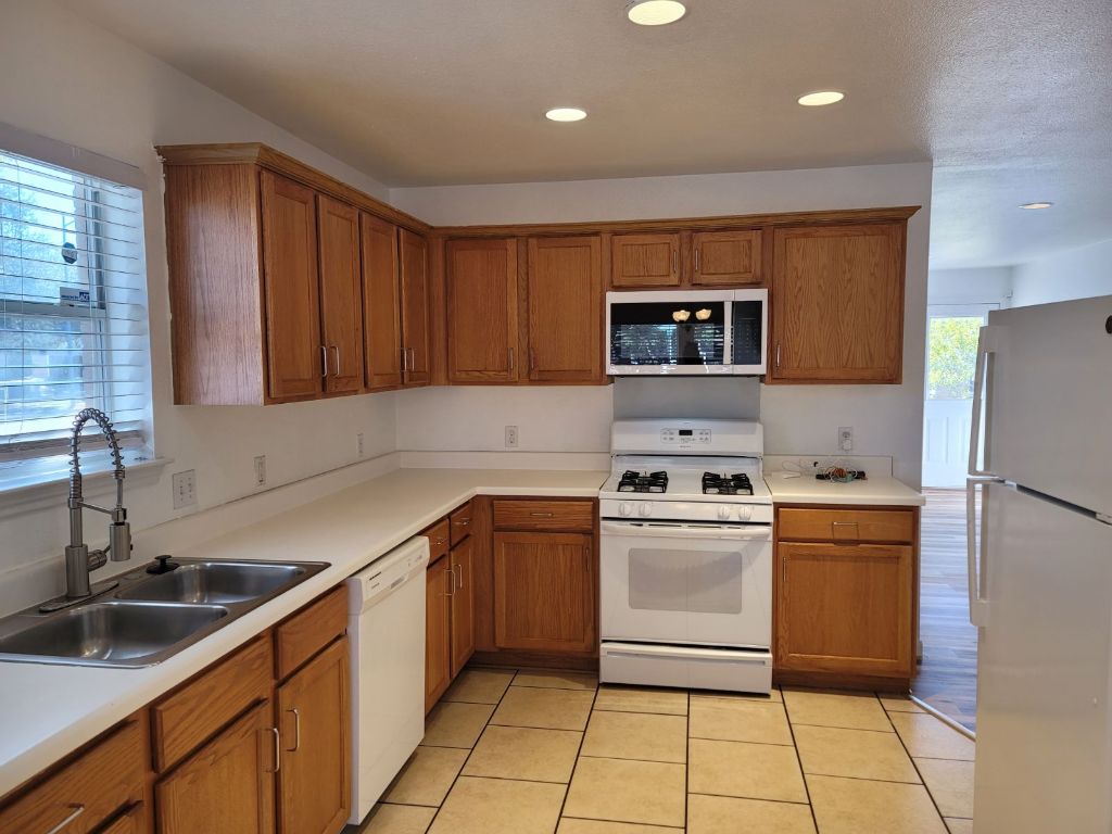 707 Windledge Drive Austin, TX 78745 - Photo 10 of 25 a kitchen with a stove sink and cabinets