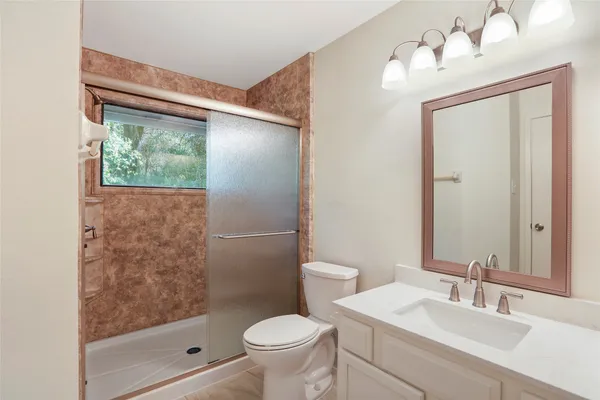 a bathroom with a sink toilet and shower