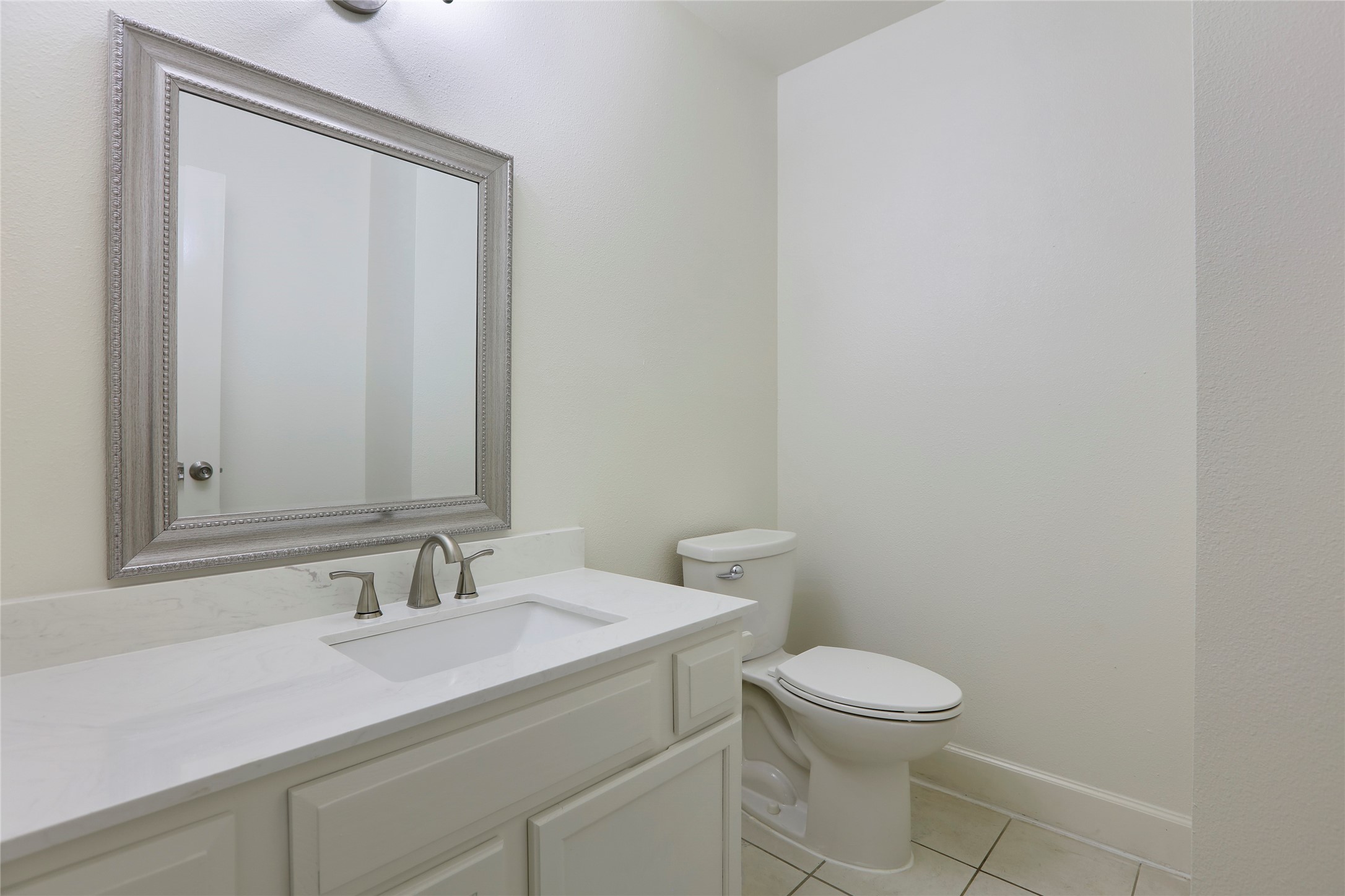 28 Sawmill Grove Lane Spring, TX 77380 - Photo 24 of 30 a bathroom with a toilet a sink and mirror