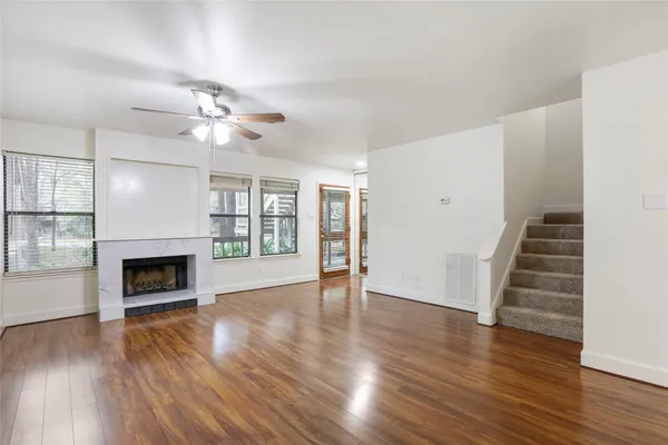 wooden floor fireplace and windows in a room