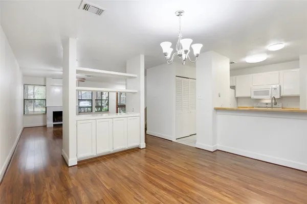 a view of kitchen with granite countertop cabinets a sink and stainless steel appliances