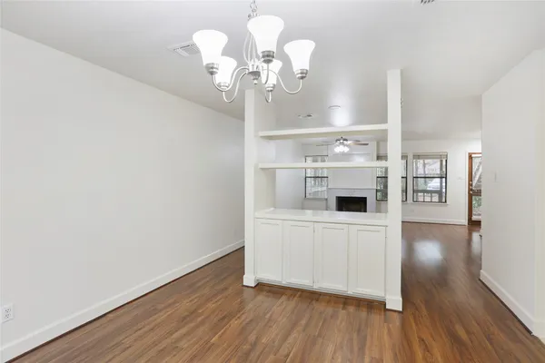 a view of a room with wooden floor