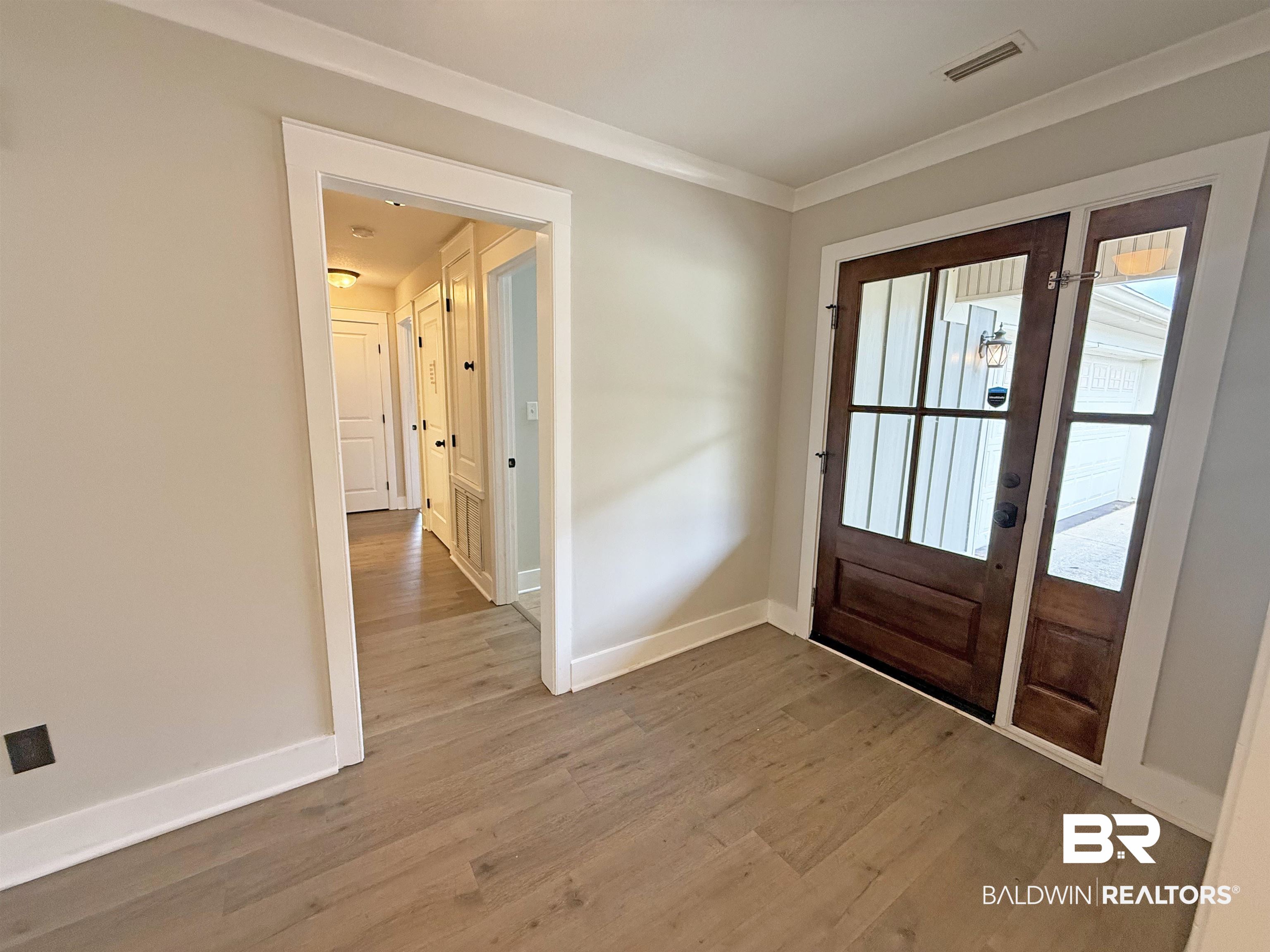 22023 Garland Loop Silverhill, AL 36576 - Photo 3 of 33 Foyer entrance with wood finished floors and crown molding