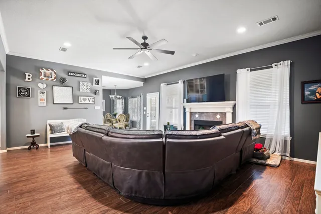 a living room with fireplace furniture and a flat screen tv