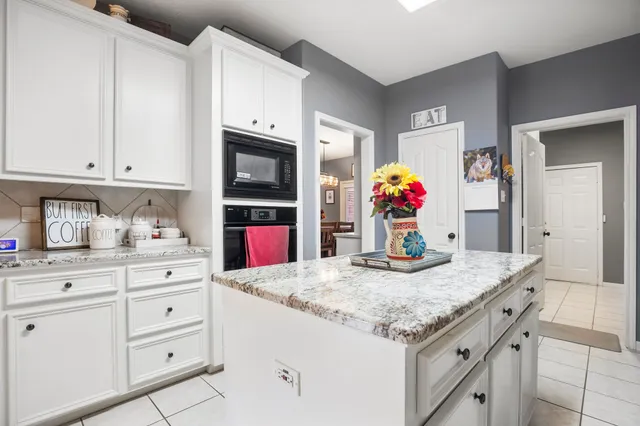 a kitchen with granite countertop cabinets and sink