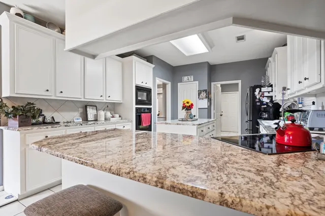 a view of kitchen sink cabinets and window