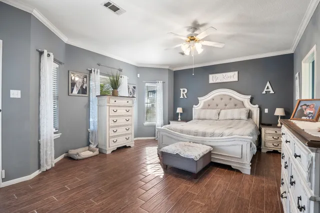a spacious bedroom with a bed and a chandelier