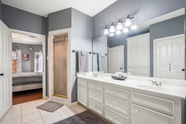 a bathroom with a sink double vanity and a mirror