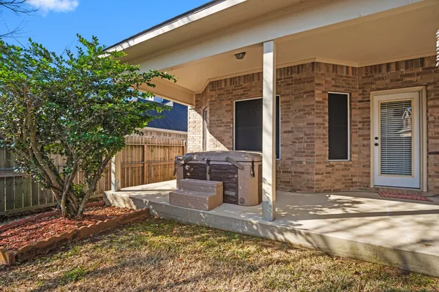 a backyard of a house with barbeque oven fire pit table and chairs