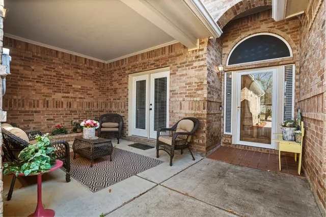 a view of living room with patio furniture and potted plants