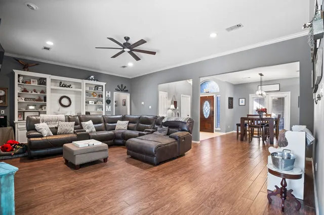 a living room with furniture and wooden floor