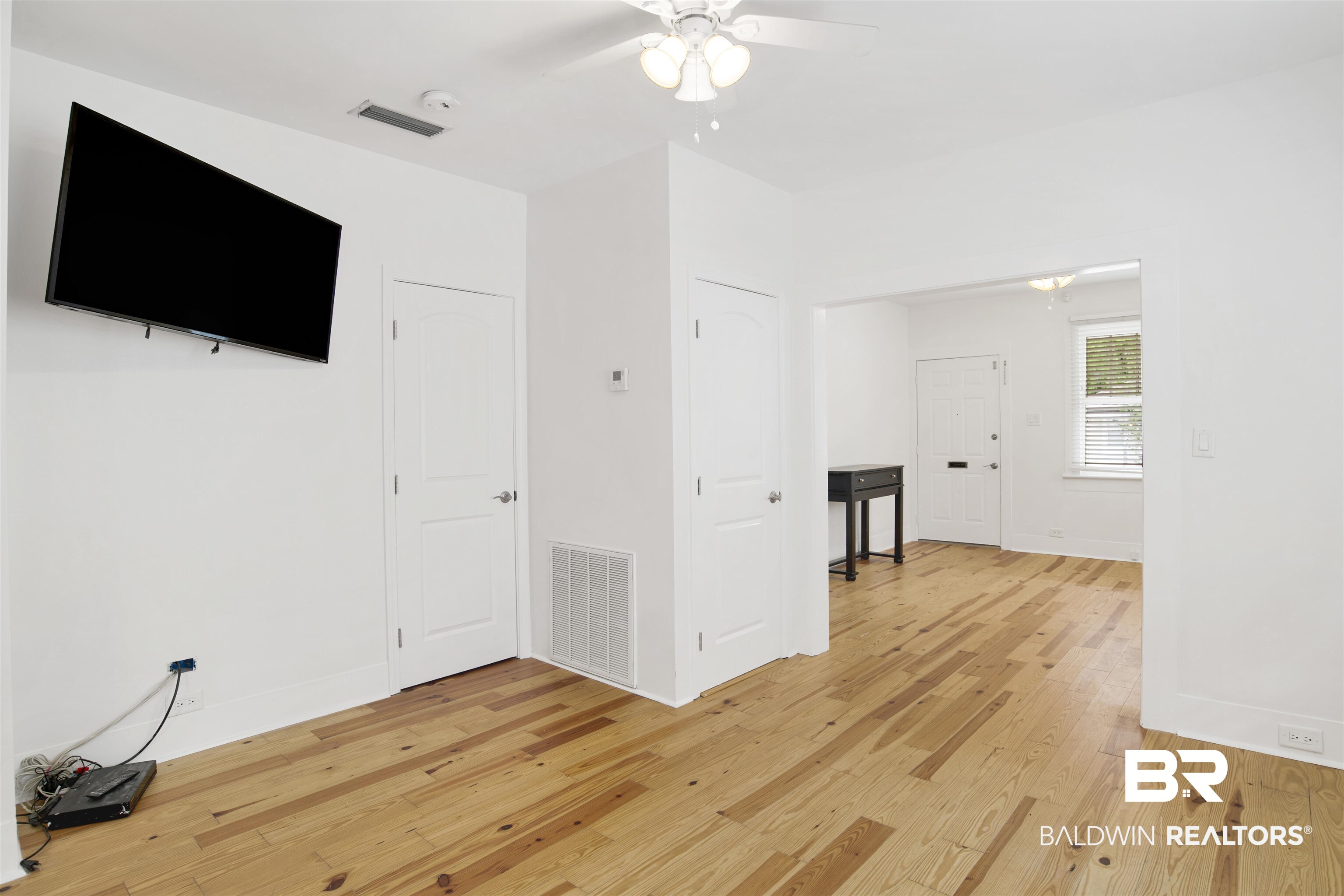 507 Holcombe Avenue Mobile, AL 36606 - Photo 17 of 28 Unfurnished living room with light wood finished floors, a ceiling fan, and baseboards