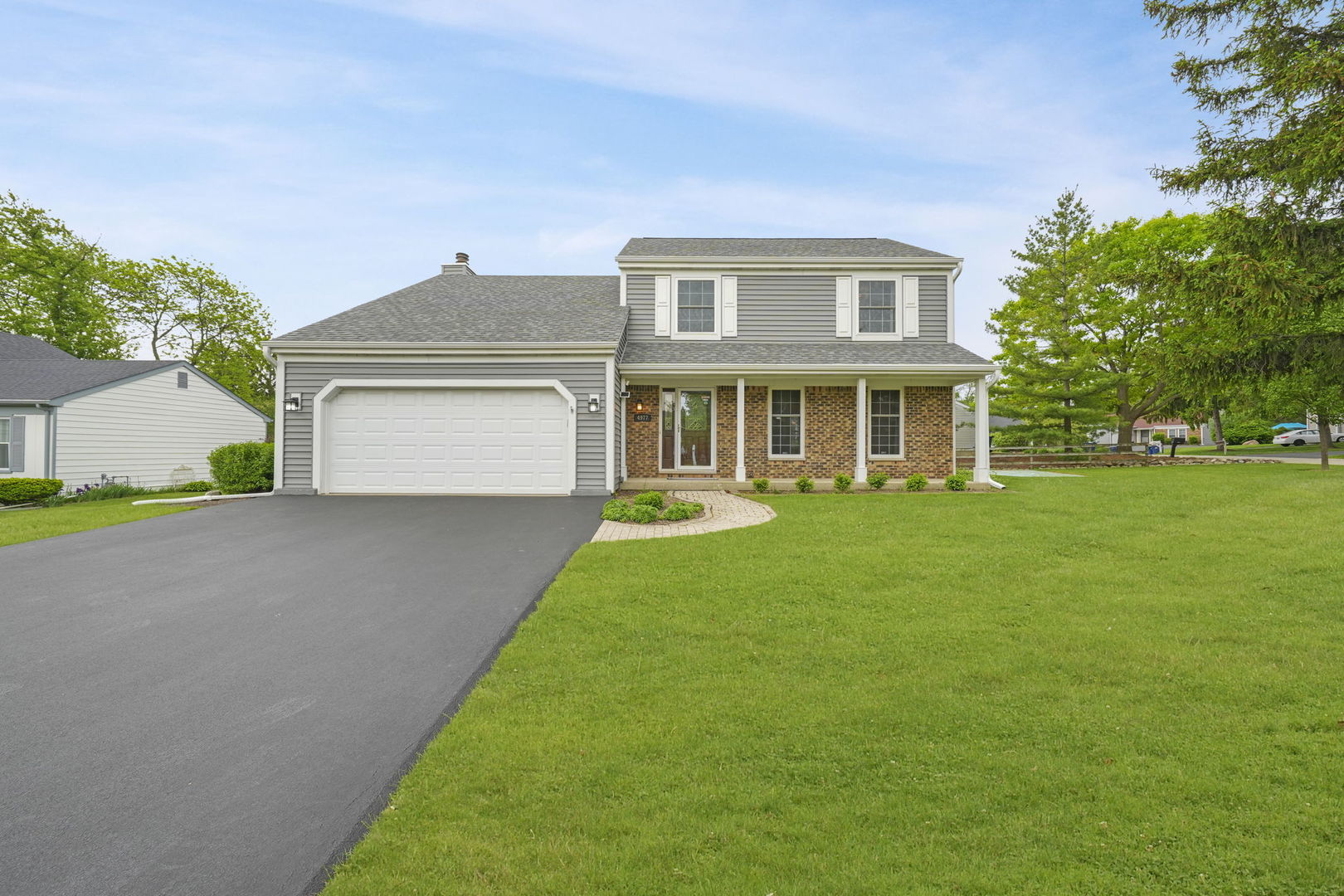 4977 Prairie Oak Road Gurnee, IL 60031 - Photo 1 of 26 a front view of a house with a yard and garage