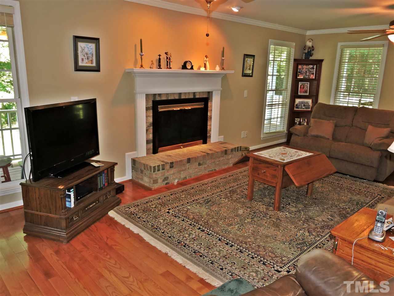 660 Charlie Reade Road Timberlake, NC 27583 - Photo 11 of 25 a living room with furniture and a flat screen tv