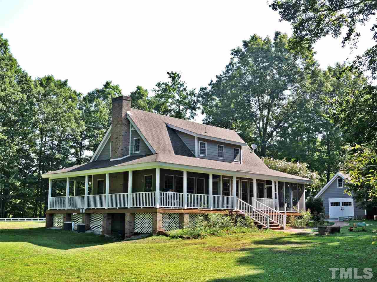 660 Charlie Reade Road Timberlake, NC 27583 - Photo 7 of 25 a front view of a house with a yard table and chairs