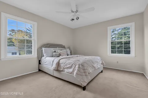a bed sitting in a bedroom next to a window