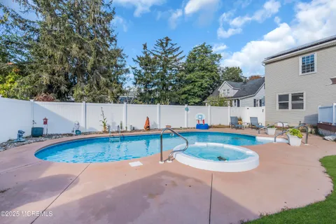 a swimming pool with outdoor seating and yard