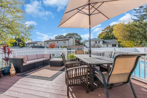a view of a roof deck with furniture