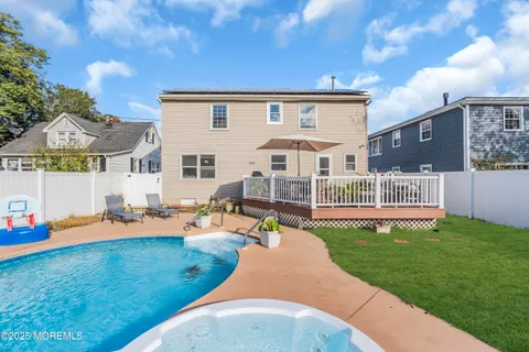 a view of a house with a backyard porch and sitting area