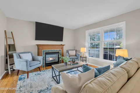 a living room with furniture fireplace and a flat screen tv