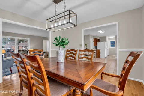 a view of a dining room with furniture and a chandelier