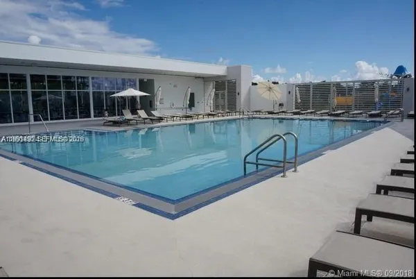a view of a swimming pool and outdoor seating
