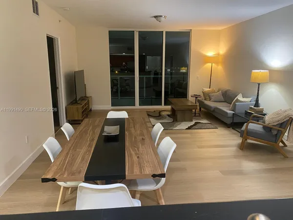 a living room with furniture window and a flat screen tv