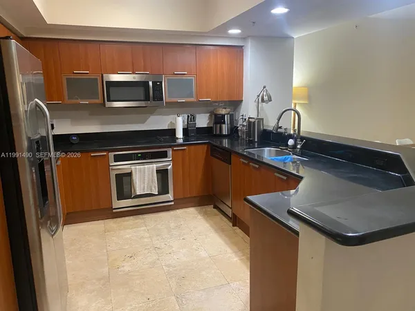 a kitchen with kitchen island a sink appliances and cabinets