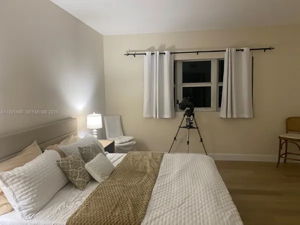 a bed room with a bed window and a table