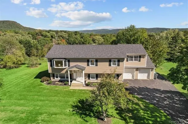 an aerial view of a house with table and chairs
