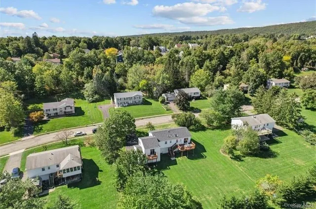an aerial view of a house with a yard