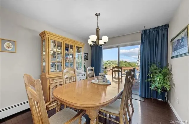 a dining room with furniture window and wooden floor