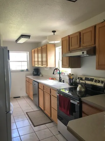a view of workspace with furniture and a window