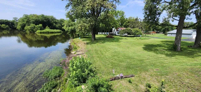 a view of a deck with couches table and chairs with wooden floor and fence