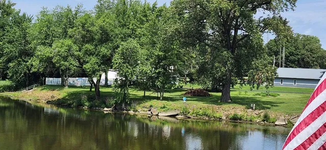 a view of a patio with lawn chairs floor to ceiling window and a yard