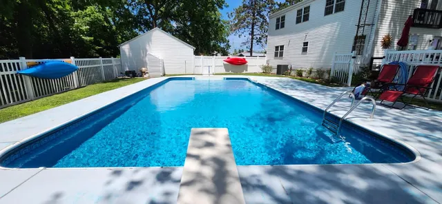 a large kitchen with a stove a refrigerator and a sink