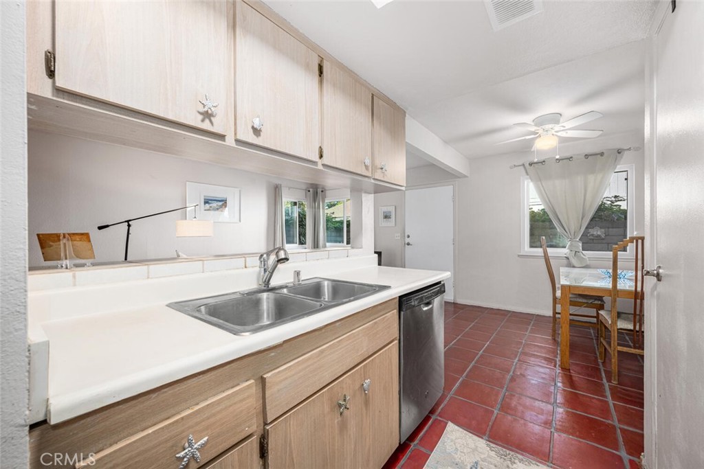 16393 Del Oro Circle, Unit 123 Huntington Beach, CA 92649 - Photo 11 of 24 a kitchen with a sink and cabinets