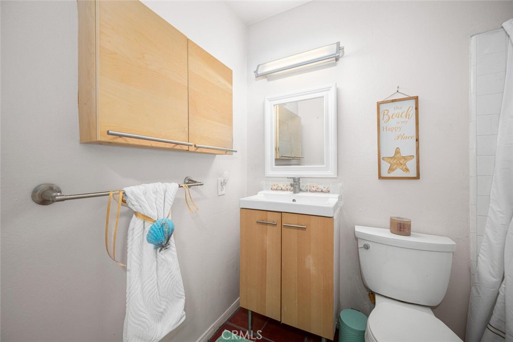 16393 Del Oro Circle, Unit 123 Huntington Beach, CA 92649 - Photo 15 of 24 a bathroom with a toilet sink and mirror