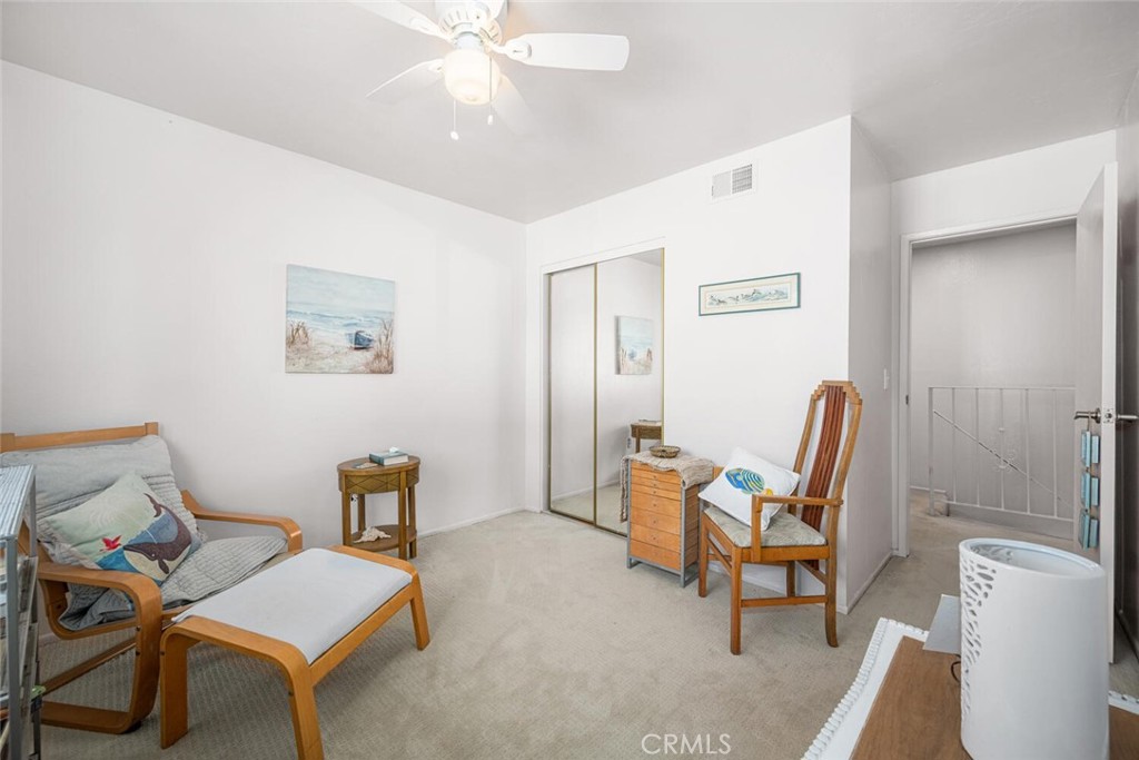 16393 Del Oro Circle, Unit 123 Huntington Beach, CA 92649 - Photo 17 of 24 a living room with furniture and a chair