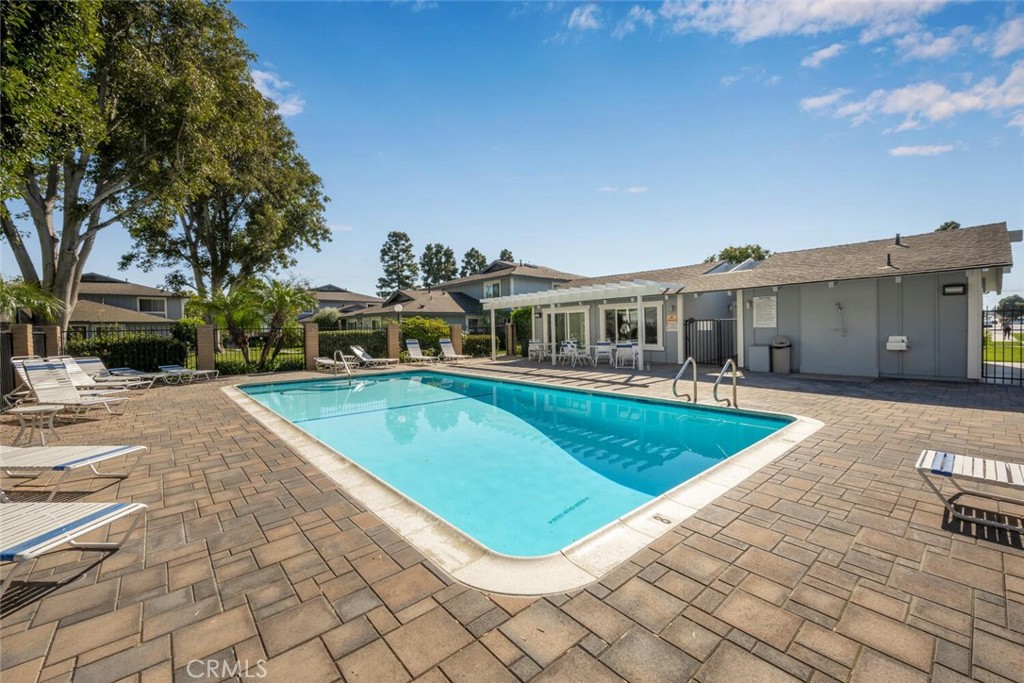 16393 Del Oro Circle, Unit 123 Huntington Beach, CA 92649 - Photo 22 of 24 a view of a house with swimming pool