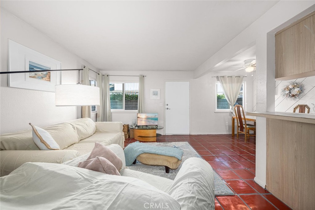 16393 Del Oro Circle, Unit 123 Huntington Beach, CA 92649 - Photo 6 of 24 a bedroom with furniture and a couch