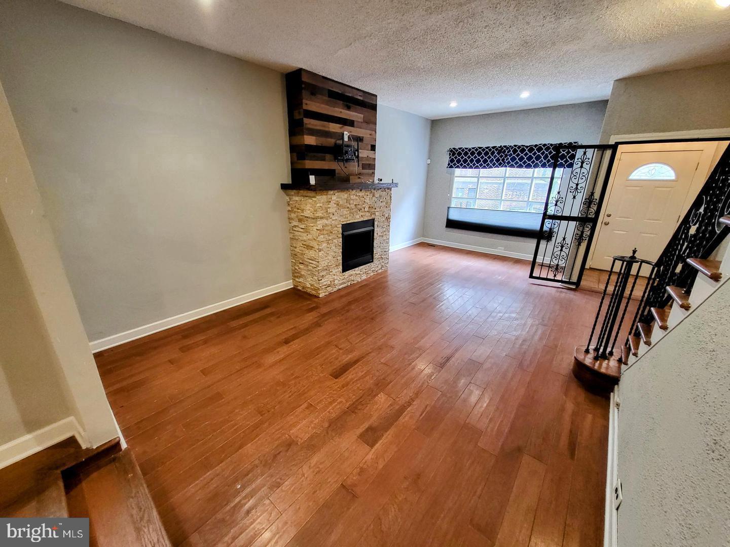 2237 Federal Street Philadelphia, PA 19146 - Photo 4 of 25 a view of an empty room with a fireplace and a window