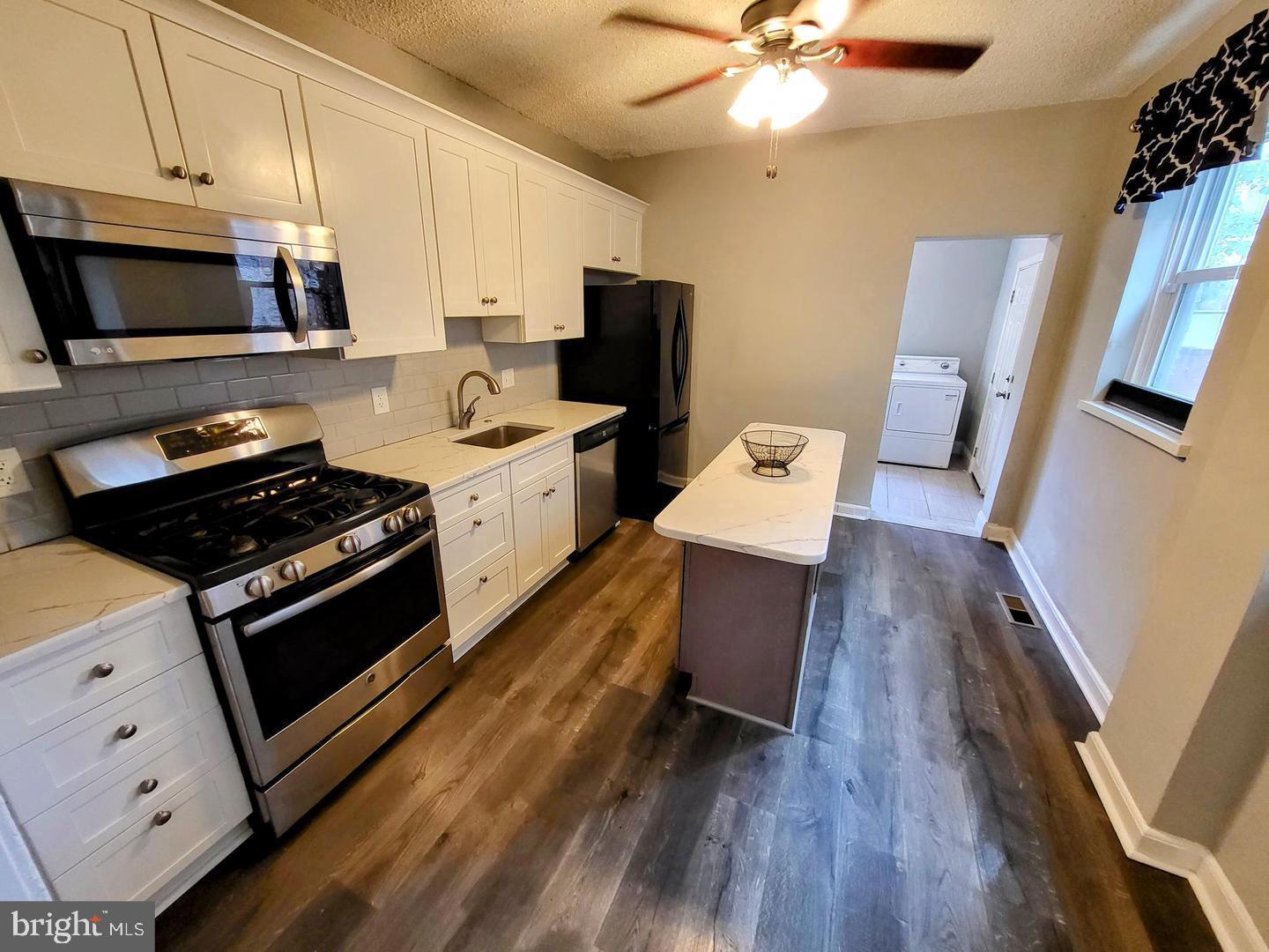 2237 Federal Street Philadelphia, PA 19146 - Photo 8 of 25 a kitchen with a stove and a microwave